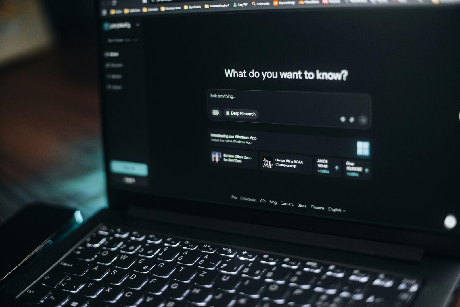 A laptop screen showing an AI assistant asking: What do you want to know?